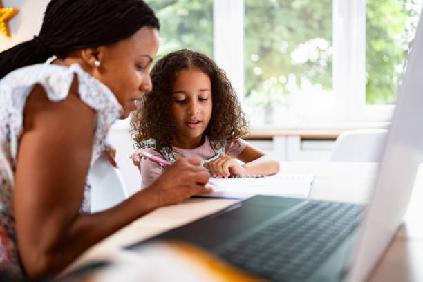 istock Multiracial girl with a help of her mother doing her homework 2162100972