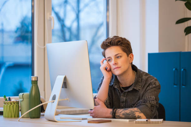 istock Overworked gen Z young woman working in an office 2162101332