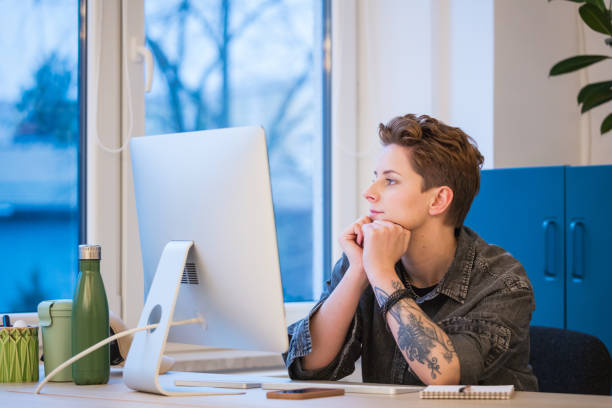 Thoughtful gen Z young woman working in an office
