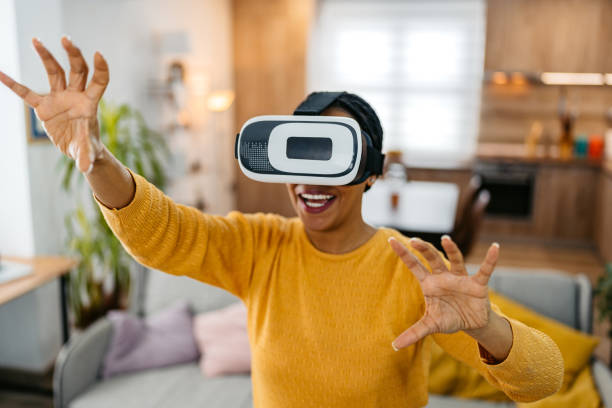 istock Young Woman Playing A Game On A Virtual Reality Headset At Home 2162102583
