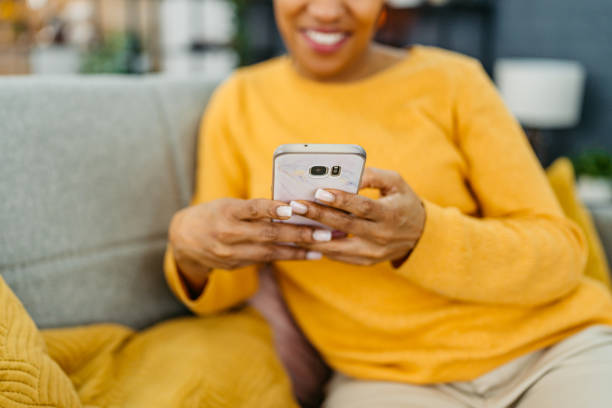 istock Young Woman Using Her Smart Phone On The Sofa At Home 2162102935