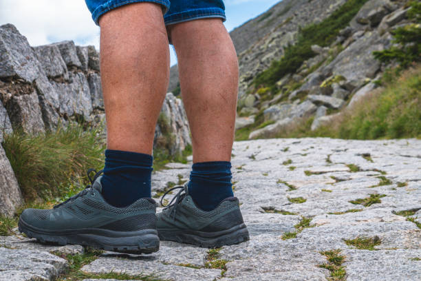 istock man in mountain boots and long black socks on mountain trail 2162106929
