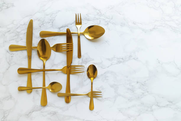 istock Gold Cutlery On A Marble Counter Top 2162109927