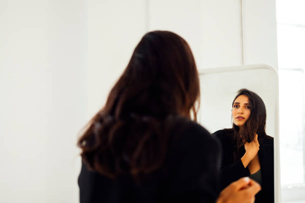 istock Reflection of young woman expecting baby in large rectangular mirror 2162112448