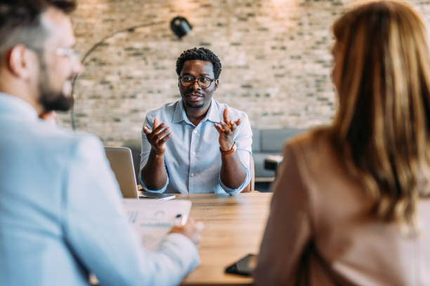 istock Group of business persons talking in the office. 2162112650