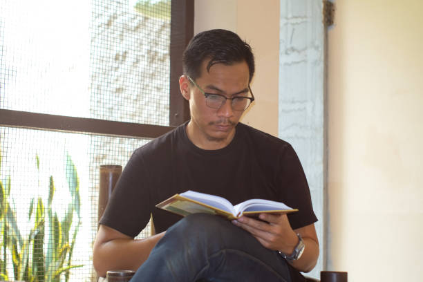 istock A Southeast Asian man reading book sitting on the bamboo chair at the terrace 2162112708