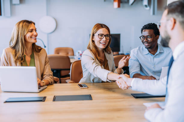 istock Businesspeople shaking hands across the table. 2162112735