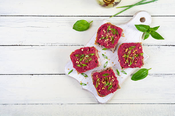 istock Toasts with beetroot, chopped nuts and herbs. Vegan bruschetta with beet 2162113134