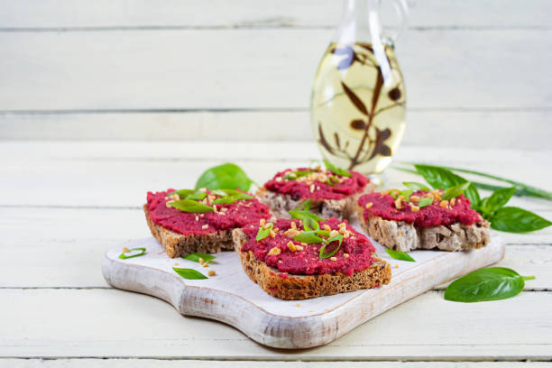 istock Toasts with beetroot, chopped nuts and herbs. Vegan bruschetta with beet 2162113135