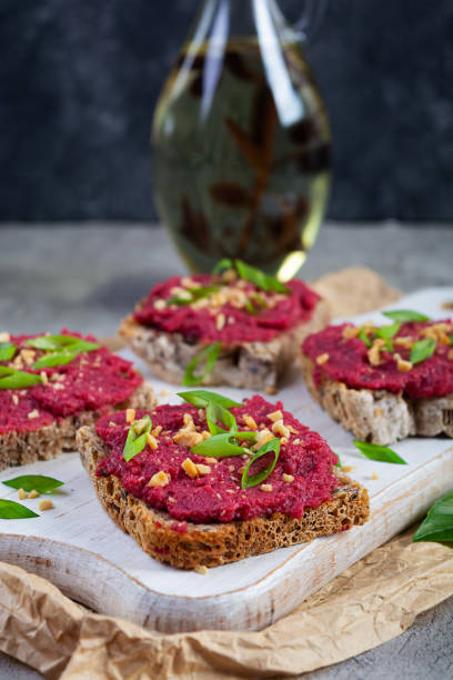 istock Toasts with beetroot, chopped nuts and herbs. Vegan bruschetta with beet 2162113144