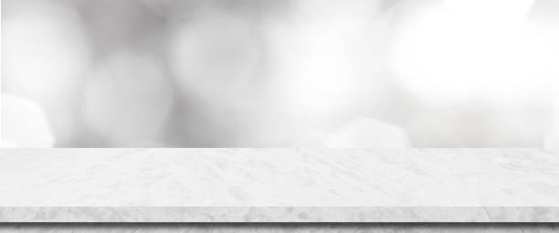 istock Empty white table top, counter, desk background over blur perspective bokeh light background, White marble stone table, shelf and blurred kitchen restaurant for food, product display mockup, template 2162114186