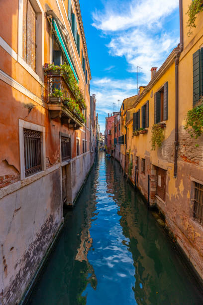 istock Narrow canal framed between colorful buildings. 2162115056