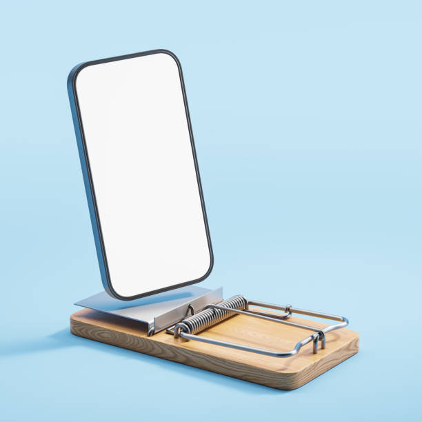 Wooden mousetrap and mock up large phone screen, online scam