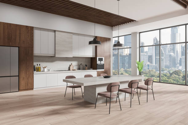 istock Beige home kitchen interior with stone table and chairs, cabinet and window 2162115408