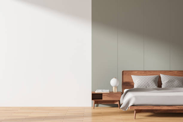 istock Stylish hotel bedroom interior with bed, nightstand with decor and mock up wall 2162115449