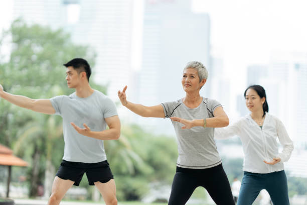 istock Asian people practicing Taichi at public park in the city 2162116002