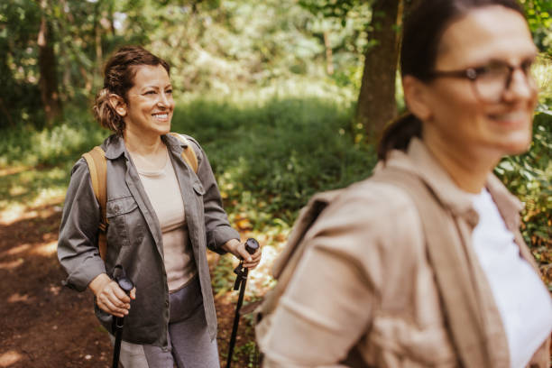 istock Women enjoying forest hike, smiling and bonding 2162116080