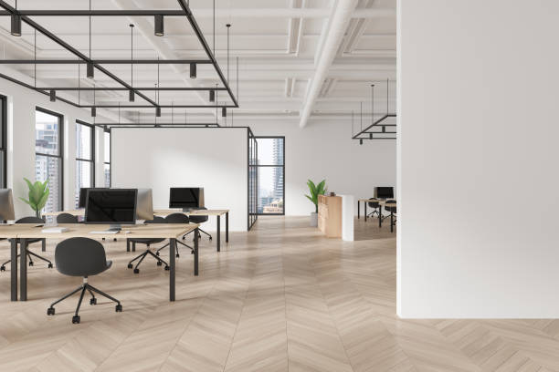 istock White coworking interior with pc monitors on tables in row, window. Mockup wall 2162116463