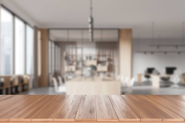 istock A blurred modern office interior background with wooden table in focus, illustrating a professional workspace, light. 3D Rendering 2162116597