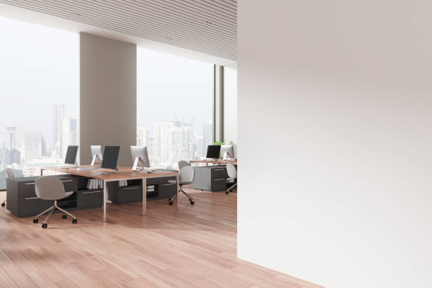 istock Office workplace interior with desks and pc computers near window. Mockup wall 2162117038