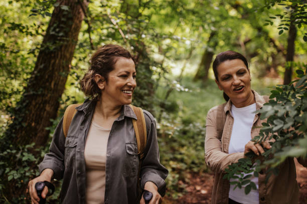 istock Women exploring nature and bonding on forest trail 2162117284