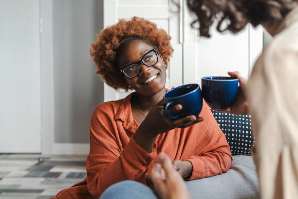 istock Two young women toasting with a cup of coffee 2162117853