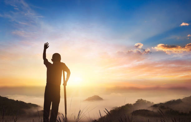istock Disabled people raising hands on top of mountain 2162117909