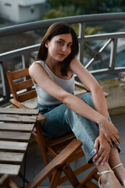 Female Sitting On Balcony During Sunset