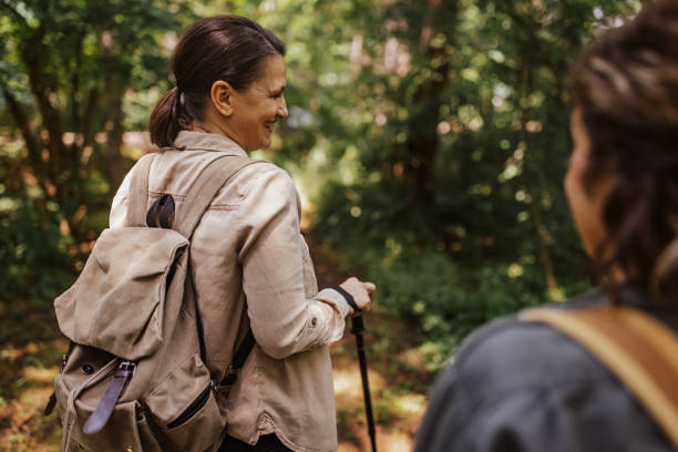 istock Hiker leading the way through a lush forest trail. 2162118272