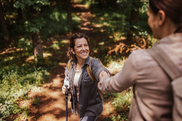 istock Two female friends hiking together 2162118425