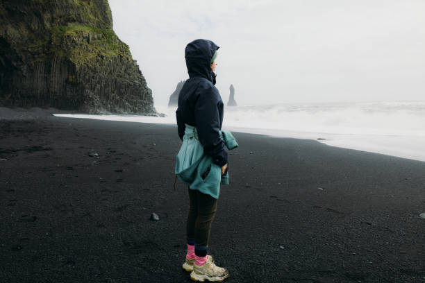 istock Traveller Walking at Dramatic Black Sand Beach Admiring Ocean Views in Iceland 2162118980