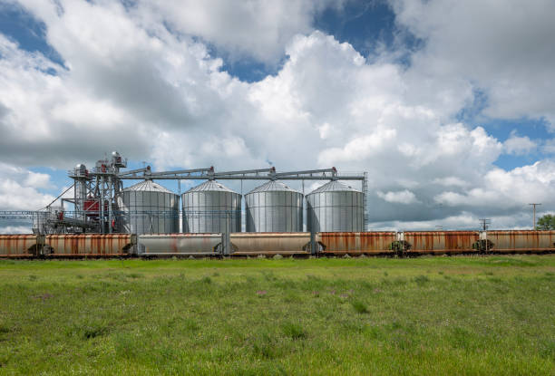 Large grain bins and parked train at the village of Lajord, Saskatchewan, Canada