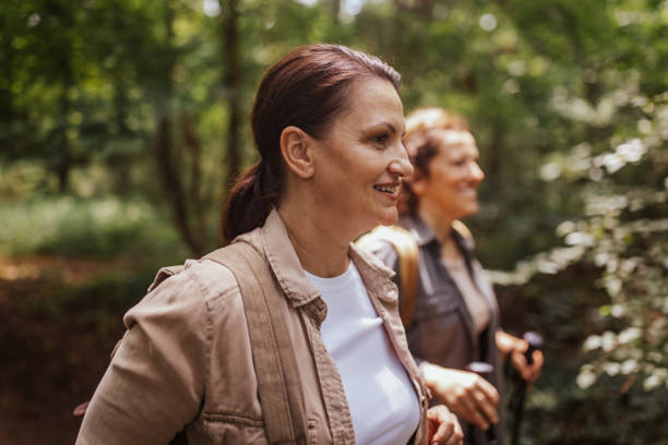 istock Two women hiking in a forest, one in focus 2162119739