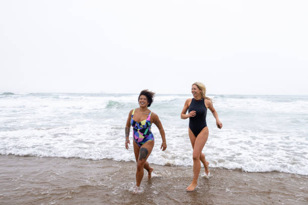 istock Friends Splashing In The Sea 2162120970