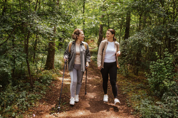 istock Casually dressed women hike on a nature trail together 2162121036