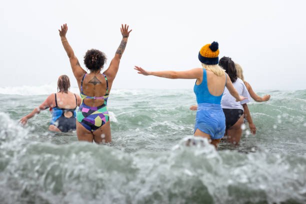 Getting Deeper In The Sea Medium shot of a group of women going swimming in the sea. They are all wearing swimming costumes and have their backs to the camera. The waves are crashing against them and the camera.
Videos are available similar to this scenario. woman cold water swimming stock pictures, royalty-free photos & images