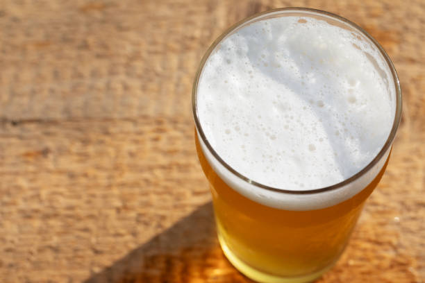 istock Craft beer in pint glass on a wooden surface 2162123279