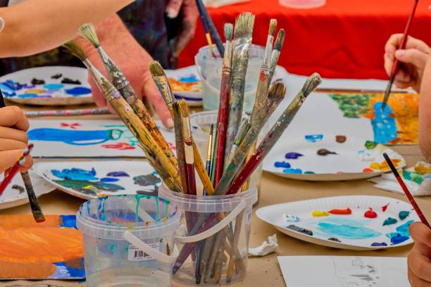 istock Master class of the artist. Mixing colors on a palette during a master class in an art studio. 2162125384