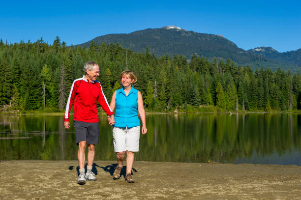 istock Senior couple explore lakeshore together 2162128036