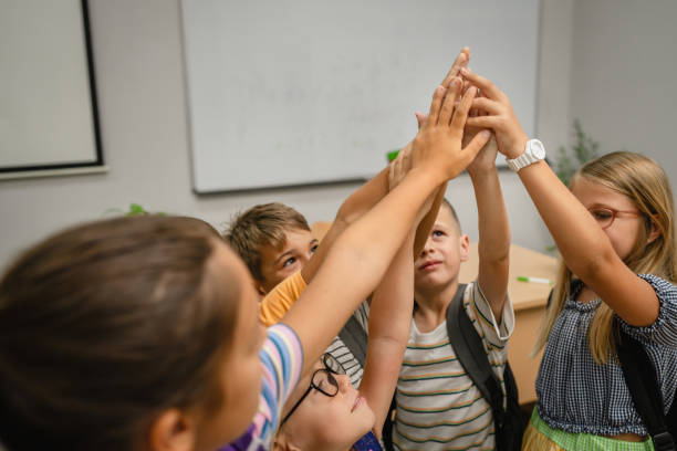 Portrait of group young students climb and have fun in the classroom