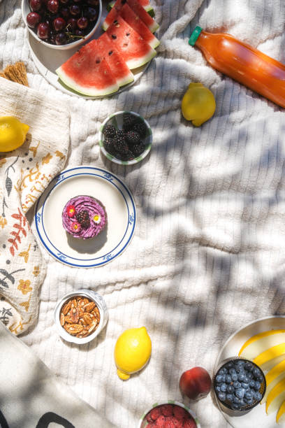 istock Garden picnic with watermelon, fruit, and cake in summer 2162129645