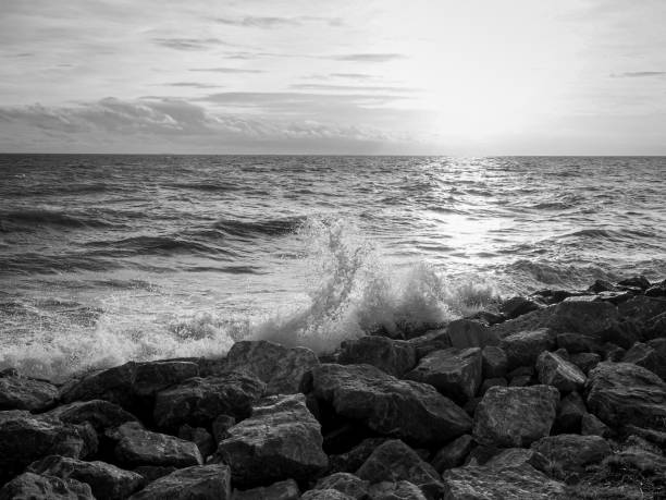 istock Beautiful sea waves with foam and sky, front view. Monochrome image 2162130185