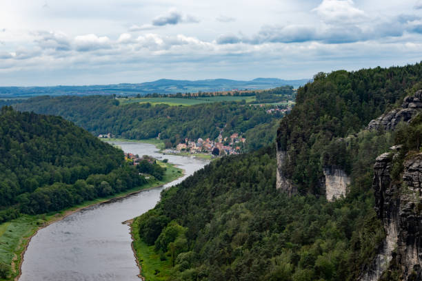istock A river flows through a lush green valley with a town in the distance 2162130197