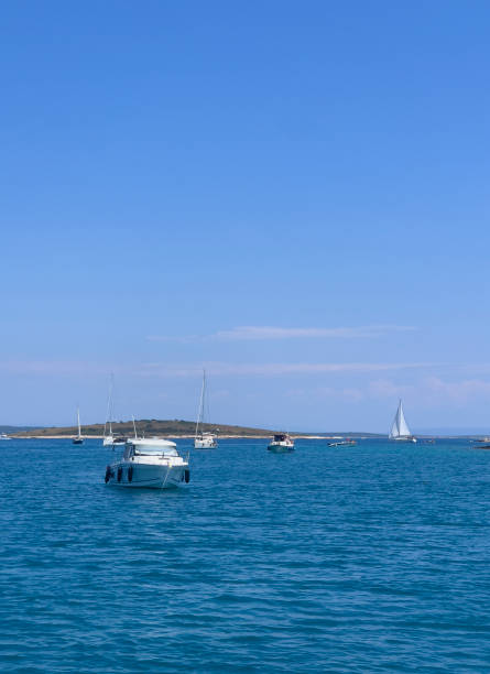 istock blue sea with boats 2162133619