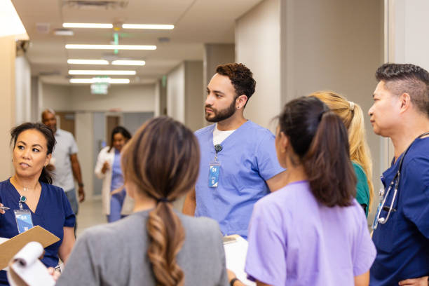 istock Diverse healthcare workers hold impromptu meeting 2162134795