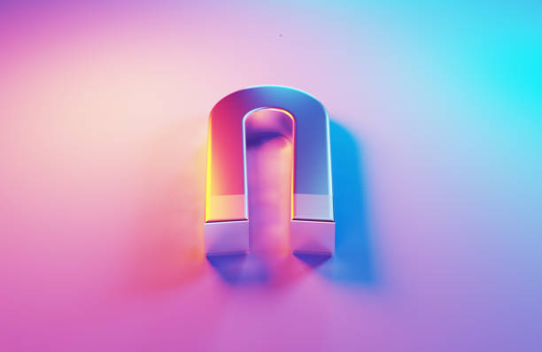 Metallic magnet which is illuminated by pink and blue light on blue background.