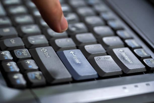 istock Mans finger about to press an enter key on a modern office laptop computer keyboard, hand hovering above the enter key, indecisive man ready to push the confirmation button abstract concept one person 2162136063