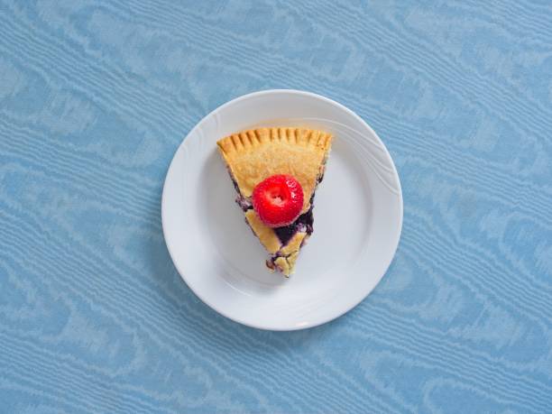 Fresh blueberry pie with bright red strawberry on top. Strawberries, a refreshing snack or garnish to any summertime food, sweet, healthy and nutritious.