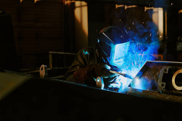 istock Factory Worker Welding Metal Parts 2162136952