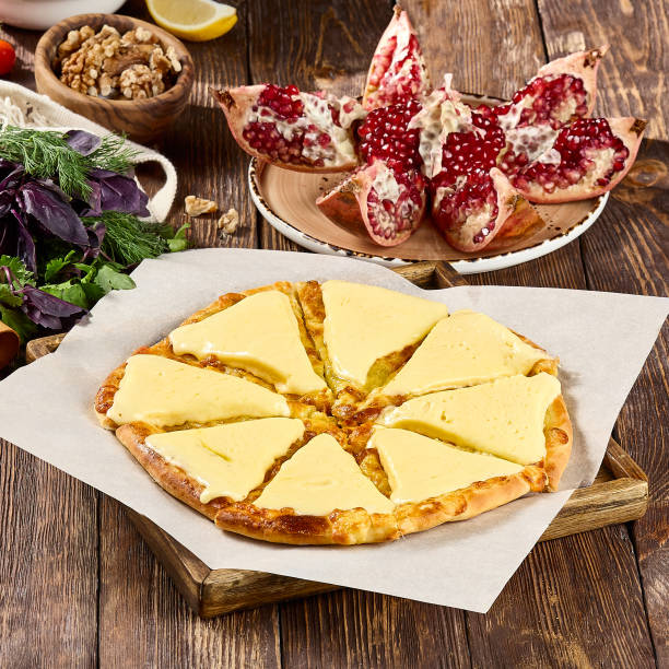 istock Traditional Georgian Cheese Pizza (Khachapuri Imeruli) with Fresh Garnishes 2162137885